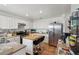 Well-lit kitchen features white cabinets, stainless steel appliances, a kitchen island, and ceramic tile flooring at 6527 Netherseal Ave, Las Vegas, NV 89139