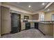 Kitchen featuring neutral toned cabinetry, granite countertops, and black appliances at 6632 Biltmore Garden St, Las Vegas, NV 89149