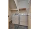 Laundry room with washer, dryer, and shelving at 6632 Biltmore Garden St, Las Vegas, NV 89149