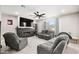 Comfortable living room features neutral color palette, cozy fireplace, and ceiling fan at 70 Pikiariki Ct, Las Vegas, NV 89183