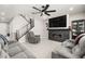 Open living room featuring a modern fireplace, large TV, ceiling fan and staircase to upper floor at 70 Pikiariki Ct, Las Vegas, NV 89183