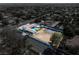 Aerial view of property showing pool, tennis court, and surrounding neighborhood at 7440 Edna Ave, Las Vegas, NV 89117