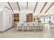 Sleek kitchen featuring a large island with seating, modern appliances, and exposed beam ceiling at 7440 Edna Ave, Las Vegas, NV 89117