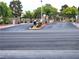Gated community entrance with well-maintained landscaping and paved roads offer security and curb appeal at 7515 Splashing Rock Dr, Las Vegas, NV 89131