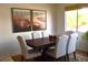 Comfortable dining room featuring wood table with seating for six and natural light at 7515 Splashing Rock Dr, Las Vegas, NV 89131