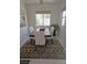 Cozy dining room featuring an area rug, modern decor, and natural light at 7515 Splashing Rock Dr, Las Vegas, NV 89131