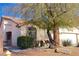 Charming single-story home with a well-manicured lawn, mature tree, and inviting entrance showcasing curb appeal at 7515 Splashing Rock Dr, Las Vegas, NV 89131