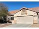 Spacious two car garage and desert landscaping of single Gathering home at 7515 Splashing Rock Dr, Las Vegas, NV 89131
