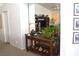 Hallway view with an accent table, mirror, house plant, and decorative items at 7515 Splashing Rock Dr, Las Vegas, NV 89131