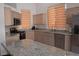 Bright kitchen with granite countertops, stainless steel appliances, and wood cabinetry at 7515 Splashing Rock Dr, Las Vegas, NV 89131