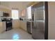 Kitchen with stainless steel appliances, tile flooring, and light wood cabinets at 7515 Splashing Rock Dr, Las Vegas, NV 89131