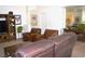 Living room with a leather sofa and armchairs, area rug, and media center with TV at 7515 Splashing Rock Dr, Las Vegas, NV 89131