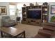 Comfortable living room with a decorative entertainment center and plush seating at 7515 Splashing Rock Dr, Las Vegas, NV 89131
