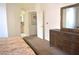 Well-lit main bedroom showcasing a wooden dresser and access to an en-suite bathroom and closet area at 7515 Splashing Rock Dr, Las Vegas, NV 89131