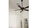 Bedroom with stylish ceiling fan and white walls that enhance the room's bright and airy feel at 7515 Splashing Rock Dr, Las Vegas, NV 89131