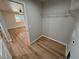 Laundry room with wood-style flooring, looking into bedroom with view to the outside at 790 E Basin, Pahrump, NV 89060