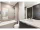 Elegant bathroom with a combined tub and shower, modern vanity, and neutral tile at 805 Magnum Cliff Ct, Henderson, NV 89012