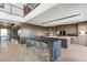 Modern kitchen with large island, ample counter space and a view into the glass wine cellar at 805 Magnum Cliff Ct, Henderson, NV 89012