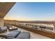 Relaxing outdoor patio with a fire pit, lounge chairs, and expansive city and mountain views at 805 Magnum Cliff Ct, Henderson, NV 89012