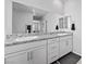 Stylish bathroom with dual sinks, a granite countertop, and a large mirror at 8976 S Park St, Las Vegas, NV 89178
