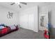 Cozy bedroom featuring a ceiling fan, plush carpet, and sliding closet doors at 8976 S Park St, Las Vegas, NV 89178