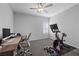Bedroom featuring a ceiling fan, desk and exercise bike equipment at 8976 S Park St, Las Vegas, NV 89178