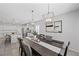Elegant dining room with stylish lighting, and an open view of the kitchen at 8976 S Park St, Las Vegas, NV 89178