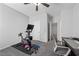 A dedicated exercise room with workout equipment, weights, and a comfortable chair at a desk at 8976 S Park St, Las Vegas, NV 89178