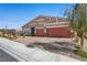 A single-story home with a brick driveway, drought-resistant landscaping, and a two-car garage at 8976 S Park St, Las Vegas, NV 89178
