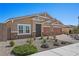 Charming single-story home with a well-manicured front yard, stone accents, and a two-car garage at 8976 S Park St, Las Vegas, NV 89178