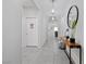 Well-lit hallway with neutral walls, tile flooring, and stylish decor leading into the living areas at 8976 S Park St, Las Vegas, NV 89178