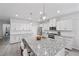 Bright, open kitchen featuring a large island, white cabinetry, and stainless steel appliances at 8976 S Park St, Las Vegas, NV 89178