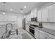 Modern kitchen features sleek white cabinetry and granite countertops at 8976 S Park St, Las Vegas, NV 89178