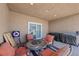 Cozy covered patio with comfortable seating and a grill, ideal for outdoor entertaining at 8976 S Park St, Las Vegas, NV 89178