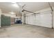 Spacious two car garage with concrete floor, shelving, and automatic door openers at 97 Parker Ranch Dr, Henderson, NV 89012