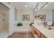 Bright bathroom featuring a shower, tub, and spacious vanity with a large mirror at 10025 Netherton Dr, Las Vegas, NV 89134