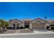 Charming single-story home with a well-manicured front yard, a two car garage and a beautiful desert landscape at 10025 Netherton Dr, Las Vegas, NV 89134