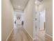 Hallway featuring wood-look floors, neutral paint, and access to various rooms at 10255 Crimson Currant St, Las Vegas, NV 89143