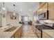 Eat-in kitchen featuring granite countertops, stainless steel appliances, and wood floors at 10255 Crimson Currant St, Las Vegas, NV 89143