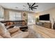 Comfortable living room featuring a large sofa, contemporary furniture, and natural light at 10255 Crimson Currant St, Las Vegas, NV 89143