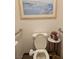 Close-up shot of a toilet and small table with flowers in a bathroom at 10522 Haywood Dr, Las Vegas, NV 89135