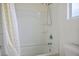 Clean white tub-shower combo with a shower curtain and white walls at 10560 La Campana St, Las Vegas, NV 89179