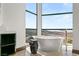 Bright bathroom with a freestanding tub in front of a large window with a hillside view at 11 Rockstream Dr, Henderson, NV 89012