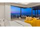 Stunning bedroom featuring a city view, balcony, and yellow sofa, creating a luxurious retreat at 11 Rockstream Dr, Henderson, NV 89012