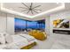 Beautiful bedroom boasts city views, a fireplace, and a comfy yellow sofa at 11 Rockstream Dr, Henderson, NV 89012