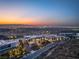 Luxury home with city views at sunset, featuring modern architecture and lush landscaping at 11 Rockstream Dr, Henderson, NV 89012