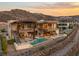Contemporary home boasts a luxurious outdoor living space with a pool, spa, and stunning sunset views at 11 Rockstream Dr, Henderson, NV 89012