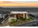 Beautiful two-story home features modern design with panoramic city views and lush landscaping at 11 Rockstream Dr, Henderson, NV 89012