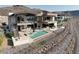 Modern two-story home featuring a pool, spa, outdoor seating, and stunning architectural design at 11 Rockstream Dr, Henderson, NV 89012