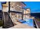Luxurious outdoor living space with a pool, spa, outdoor seating, and expansive stairs at 11 Rockstream Dr, Henderson, NV 89012